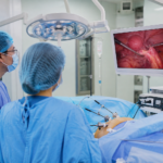 Surgeons performing minimally invasive gynecologic cancer surgery using advanced laparoscopic technology in a modern operating room.